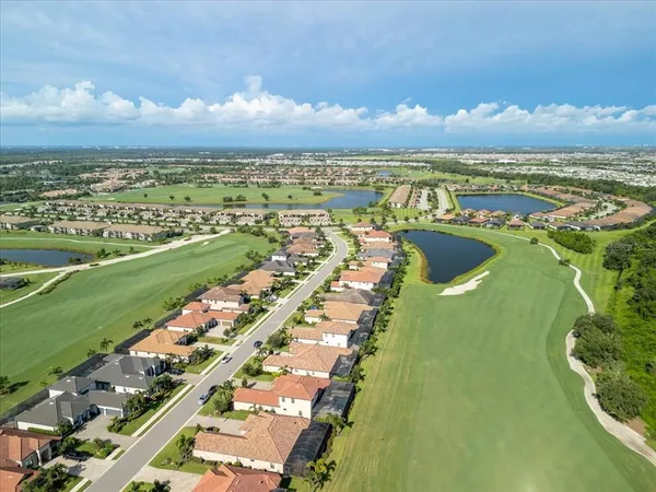a swimming pool with outdoor seating and garden