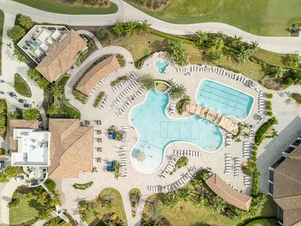 a living room with furniture flat screen tv and a large window
