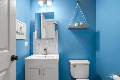 a bathroom with a toilet sink and mirror
