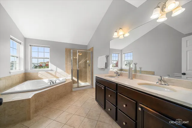 a spacious bathroom with a granite countertop tub sink and mirror