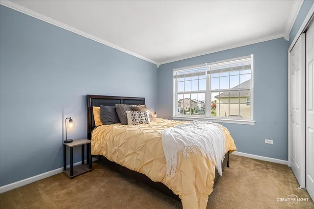 a bed sitting in a bedroom next to a window