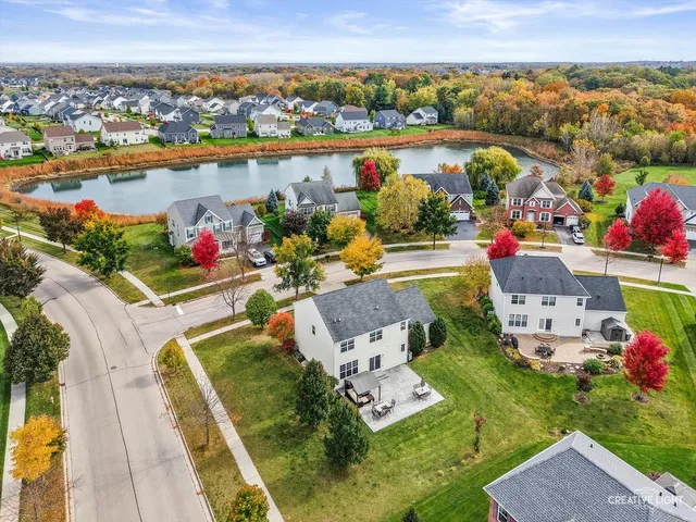 an aerial view of a house with a lake view