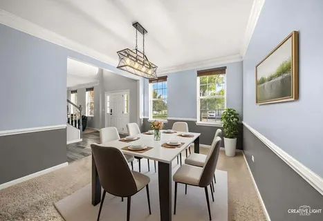 a view of a dining room with furniture wooden floor and chandelier