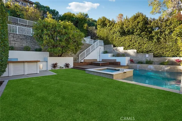 a view of a house with a backyard porch and sitting area