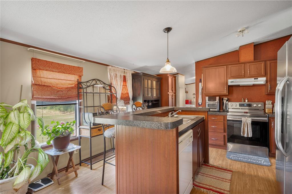 428 Pennell Road Sherman, TX 75090 - Photo 12 of 39 a kitchen with stainless steel appliances granite countertop a stove a sink and a refrigerator