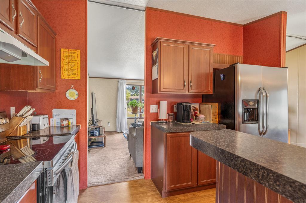428 Pennell Road Sherman, TX 75090 - Photo 13 of 39 a kitchen with stainless steel appliances granite countertop a refrigerator a stove and a sink