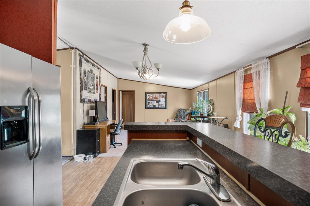 428 Pennell Road Sherman, TX 75090 - Photo 14 of 39 a kitchen with a sink and a refrigerator