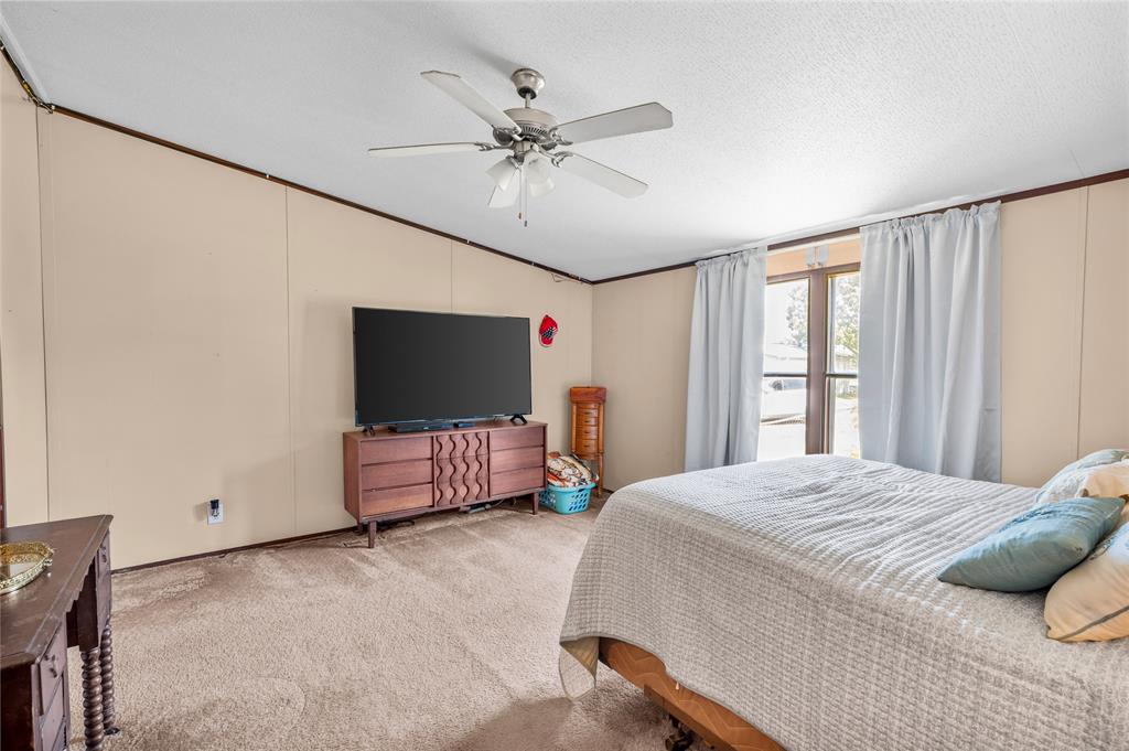 428 Pennell Road Sherman, TX 75090 - Photo 17 of 39 a bedroom with a bed and a flat screen tv