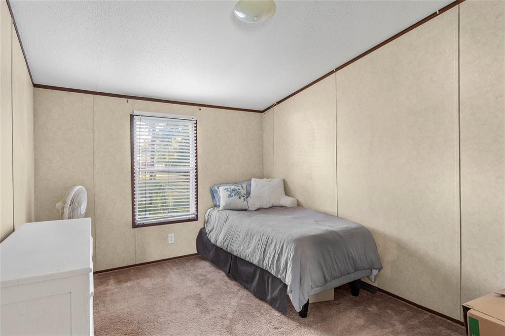 428 Pennell Road Sherman, TX 75090 - Photo 21 of 39 a bedroom with a bed lamp and a window