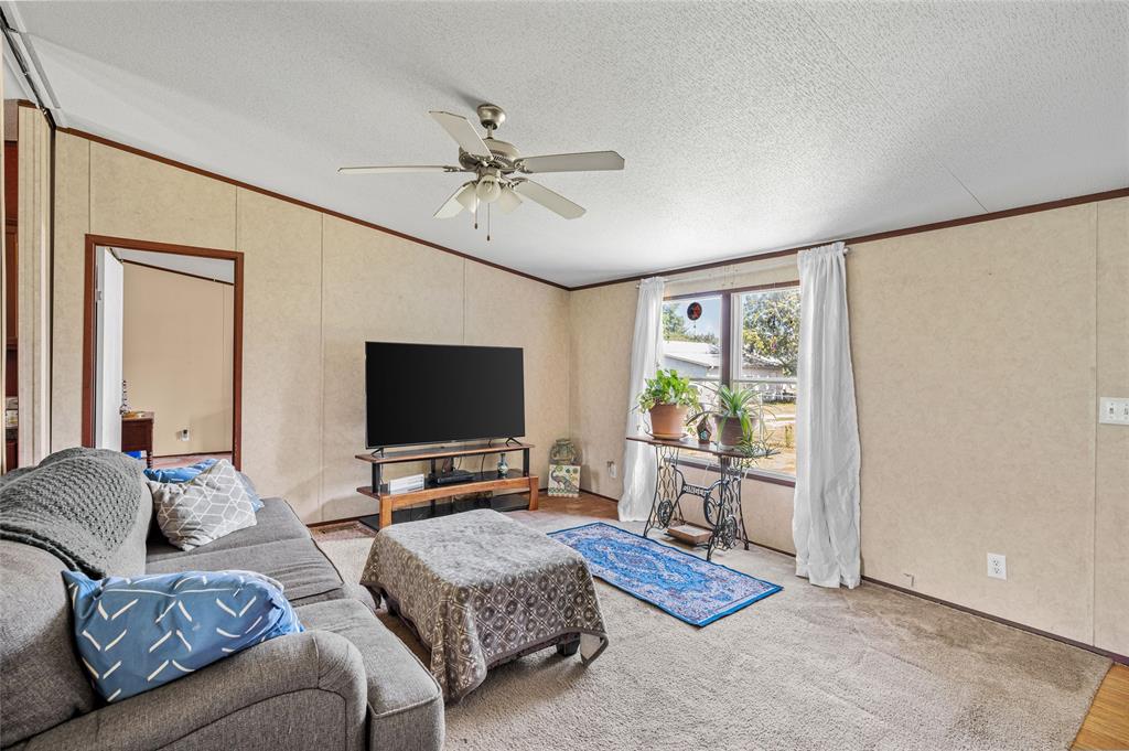 428 Pennell Road Sherman, TX 75090 - Photo 8 of 39 a living room with furniture and a flat screen tv