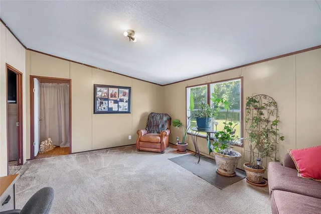 a living room with furniture and a floor to ceiling window