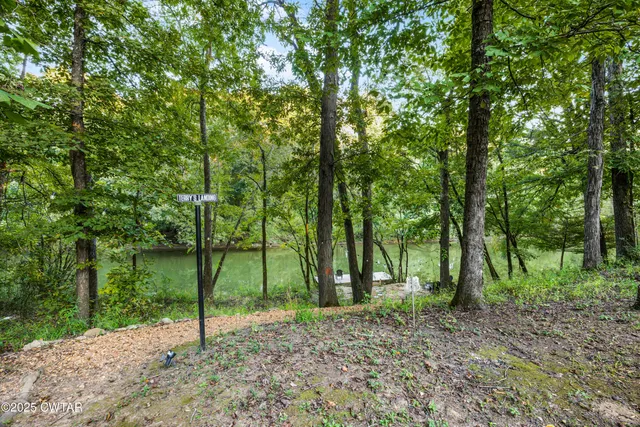 a view of a patio with a table chairs and a backyard