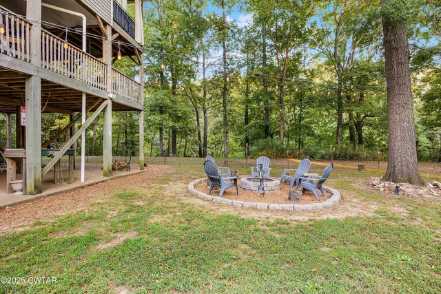 a view of a lake with a bench and trees