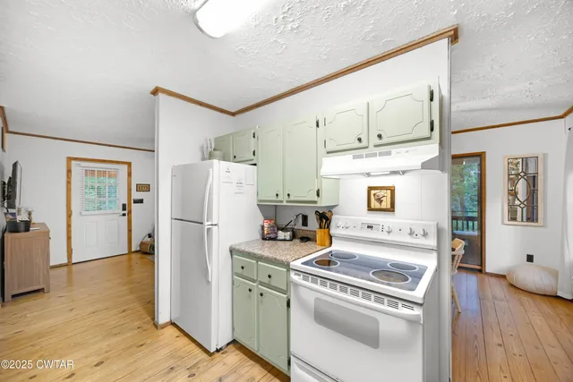 a kitchen with a refrigerator a stove top oven a sink and dishwasher