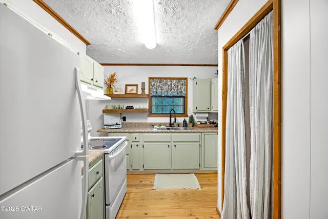 a kitchen with stainless steel appliances granite countertop a sink and cabinets
