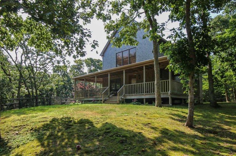 a view of house with backyard