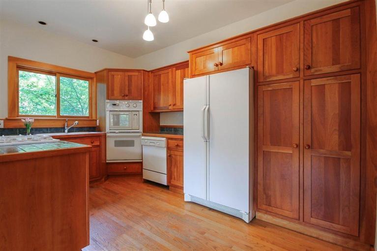 73 Pennywise Path Edgartown, MA 02539 - Photo 12 of 26 a kitchen with refrigerator cabinets and wooden floor