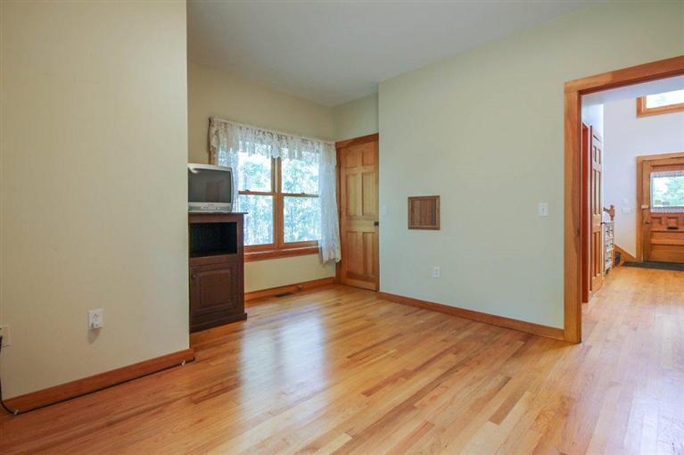 73 Pennywise Path Edgartown, MA 02539 - Photo 15 of 26 a view of empty room with wooden floor and kitchen