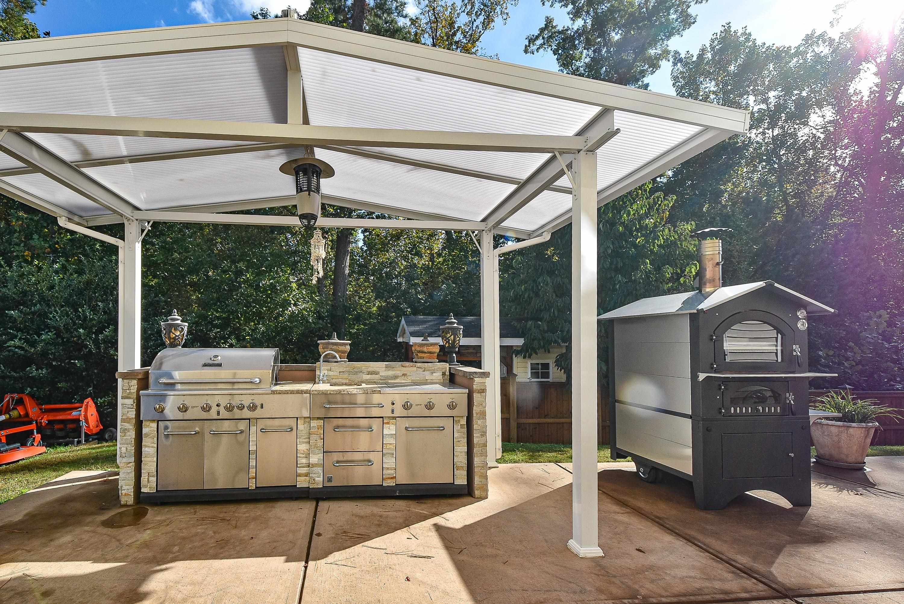 3814 Althorp Drive Raleigh, NC 27616 - Photo 24 of 30 Appliances and cover set up for wonderful outdoor entertaining. Backyard Kitchen