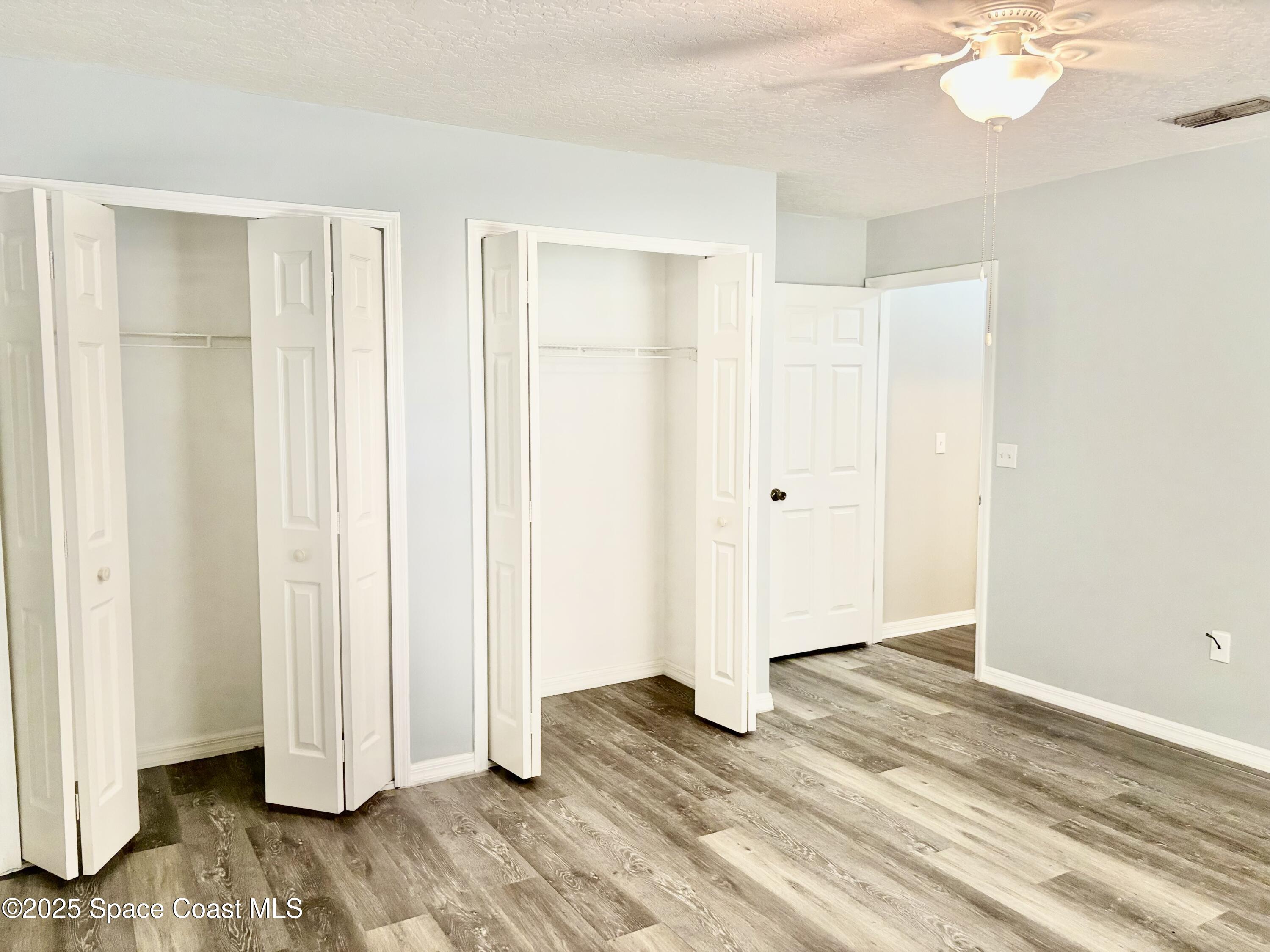 704 Cavio Avenue Northeast Palm Bay, FL 32905 - Photo 13 of 17 a view of empty room with wooden floor