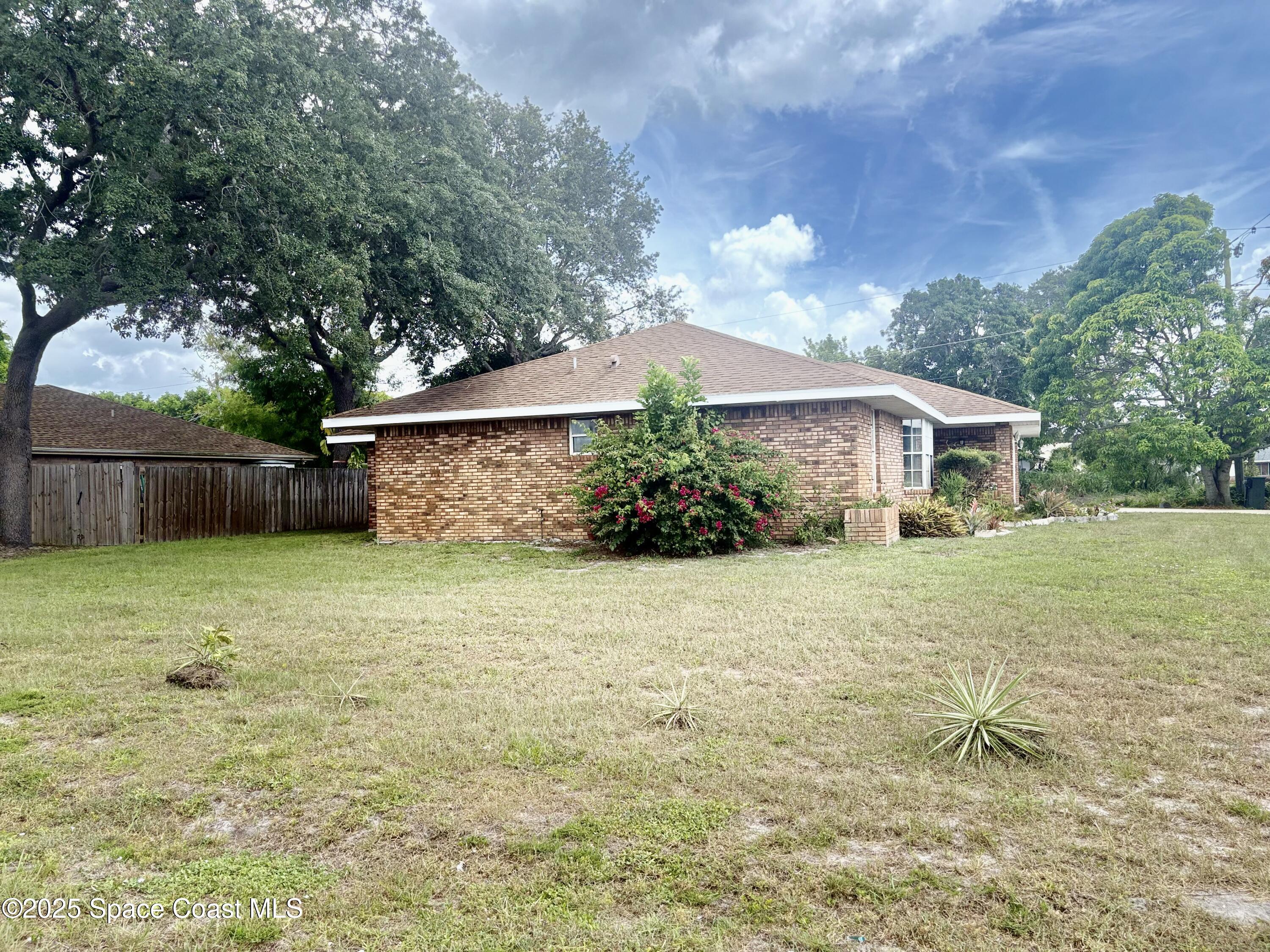 704 Cavio Avenue Northeast Palm Bay, FL 32905 - Photo 17 of 17 a front view of house with a garden