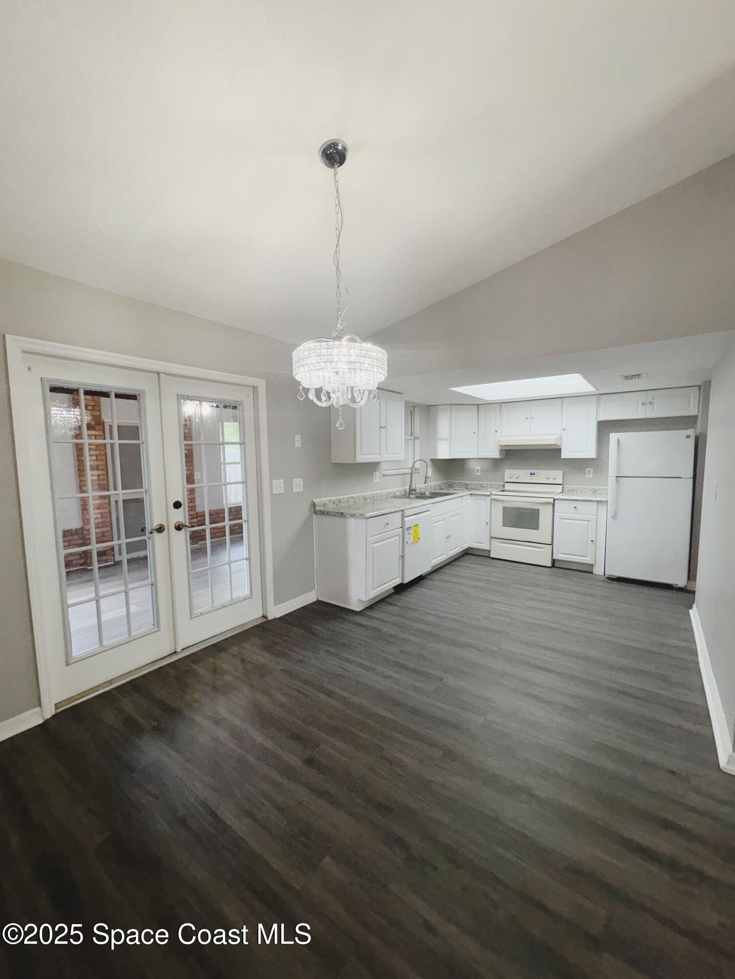704 Cavio Avenue Northeast Palm Bay, FL 32905 - Photo 6 of 17 a view of a kitchen with a sink cabinets and wooden floor