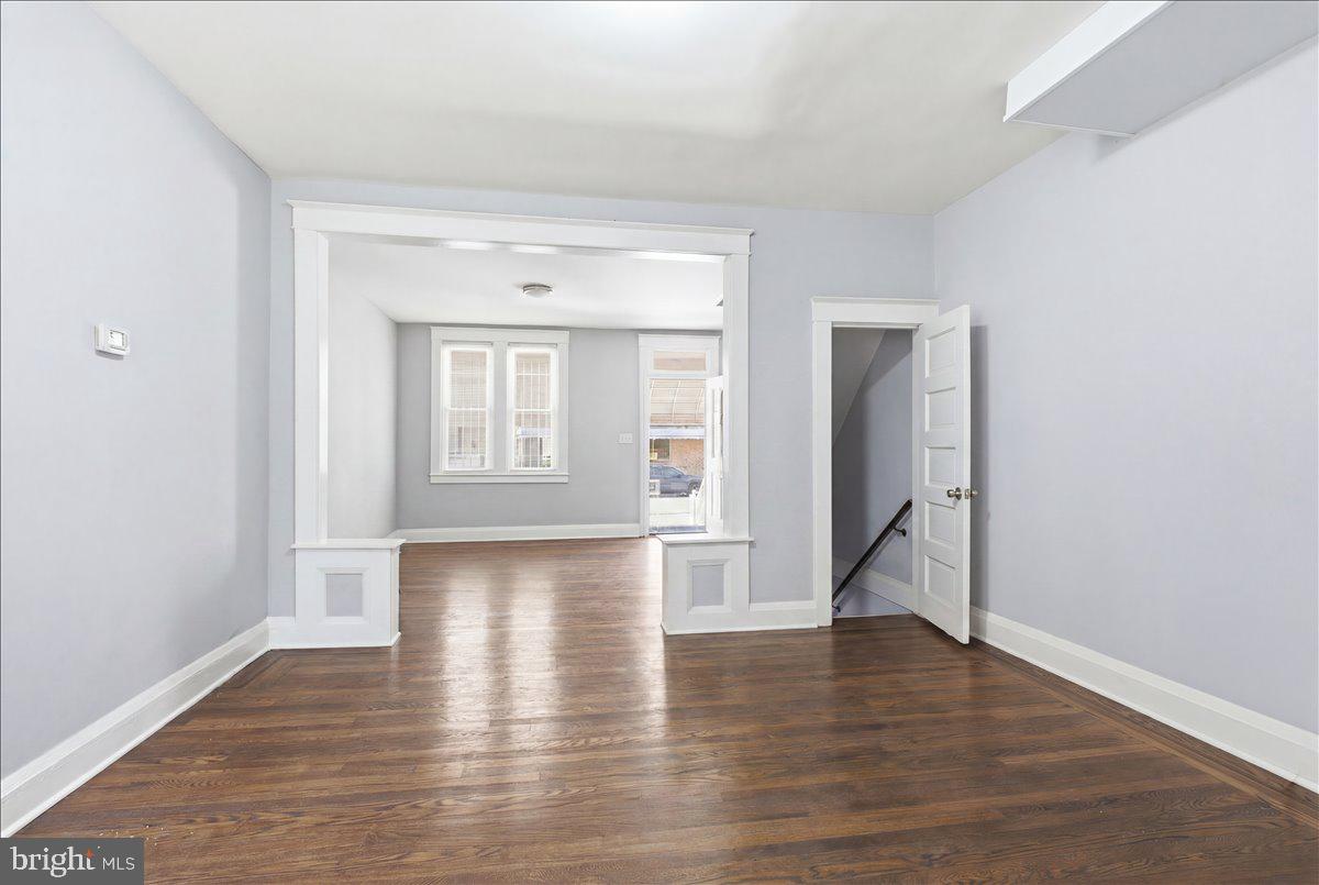 1231 North Potomac Street Baltimore, MD 21213 - Photo 11 of 25 a view of an empty room with wooden floor and a window