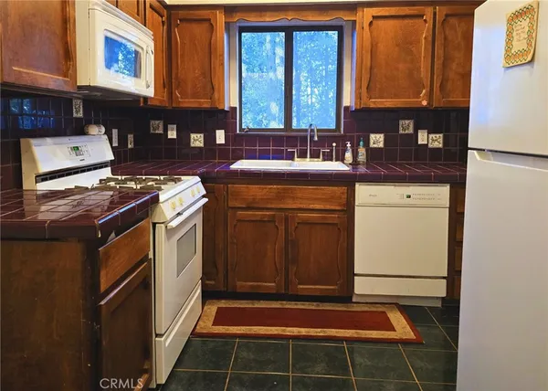 a kitchen with a stove and a microwave