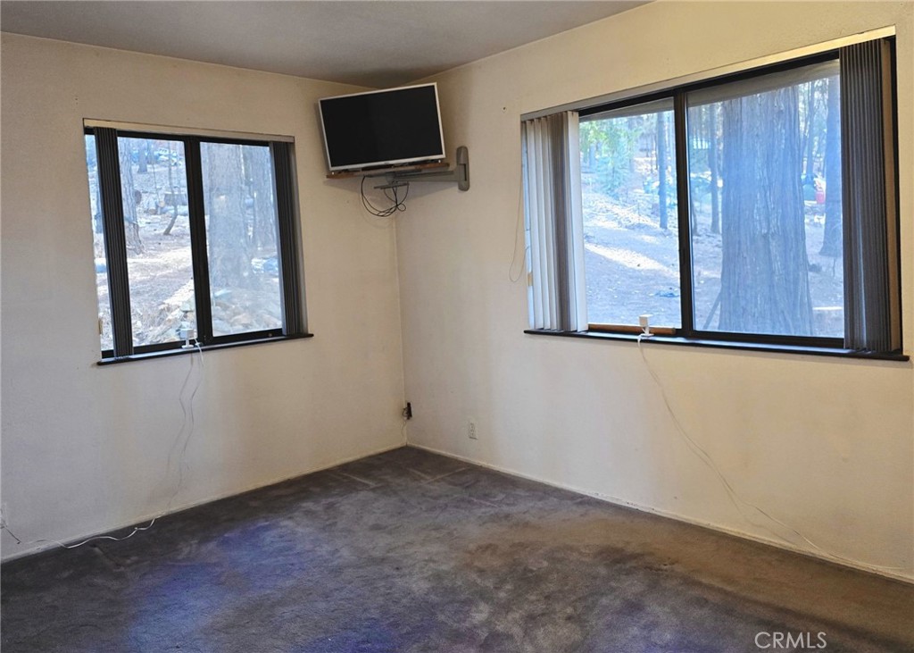 38 Weiss Hill Road Oroville, CA 95966 - Photo 18 of 27 a view of an empty room with a window and a flat screen tv