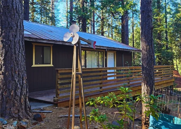 a view of a house with a large window and potted plants
