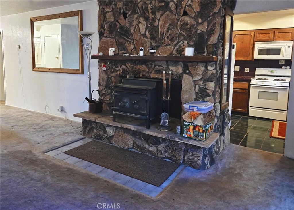 38 Weiss Hill Road Oroville, CA 95966 - Photo 8 of 27 a living room with furniture a flat screen tv and a fireplace