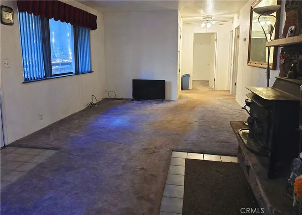 a view of livingroom with furniture hardwood floor and windows
