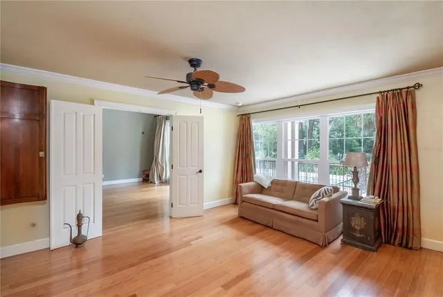 a bedroom with a bed and a lamp on dresser