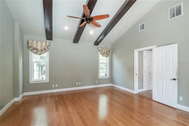 a view of a swimming pool with a patio and a yard