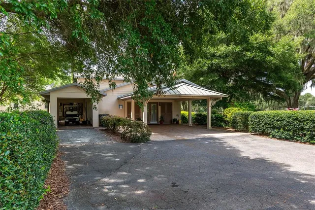 an aerial view of a house with yard swimming pool and outdoor seating