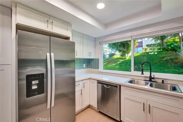 a kitchen with a stove a sink a microwave and cabinets