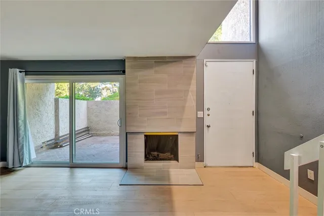a living room with a flat screen tv and a window