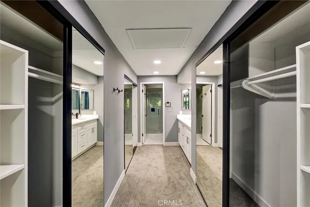 a bathroom with a double vanity sink mirror and shower