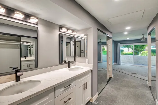 an empty room with windows and ceiling fan