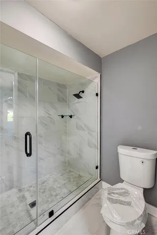 a view of an empty room with a ceiling fan and window