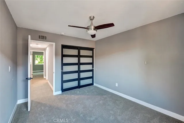 an empty room with a ceiling fan