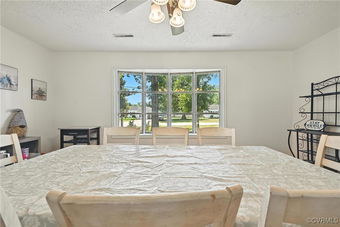 1593 Baxter Road Prince George, VA 23875 - Photo 4 of 48 a large white bed sitting in a bedroom next to a window