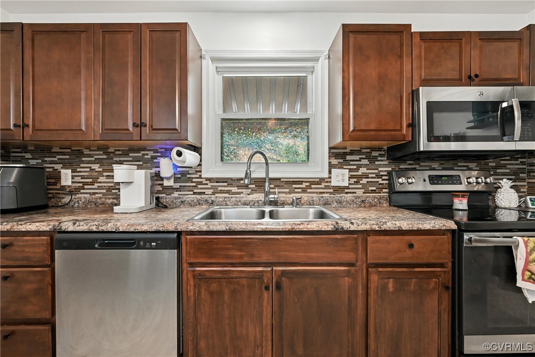 1593 Baxter Road Prince George, VA 23875 - Photo 8 of 48 a kitchen with granite countertop stainless steel appliances a sink and a microwave