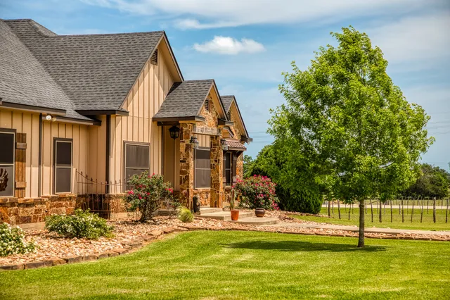 a front view of house with yard and swimming pool