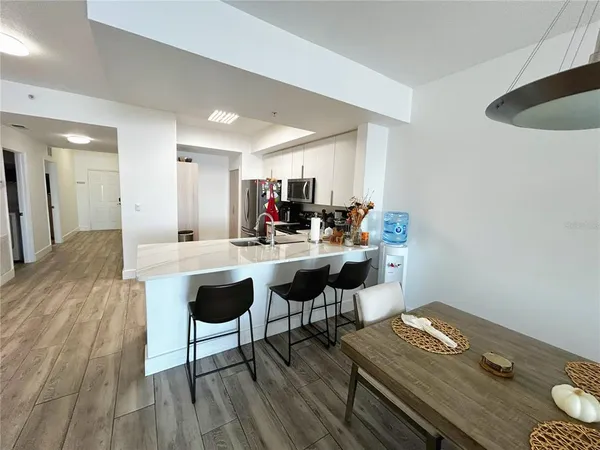 a kitchen with granite countertop a refrigerator and a stove top oven