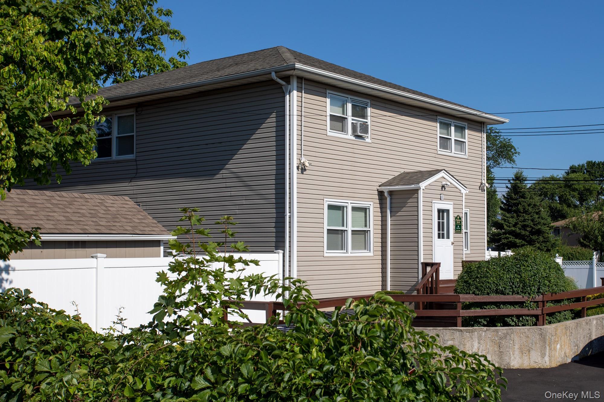 10 Laramie Road, Unit 101 West Babylon, NY 11704 - Photo 1 of 9 a front view of a house with a yard