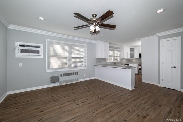 10 Laramie Road, Unit 101 West Babylon, NY 11704 - Photo 5 of 9 a view of a kitchen with wooden floor and a ceiling fan