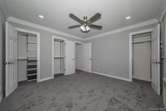 a view of a livingroom with a ceiling fan & entryway