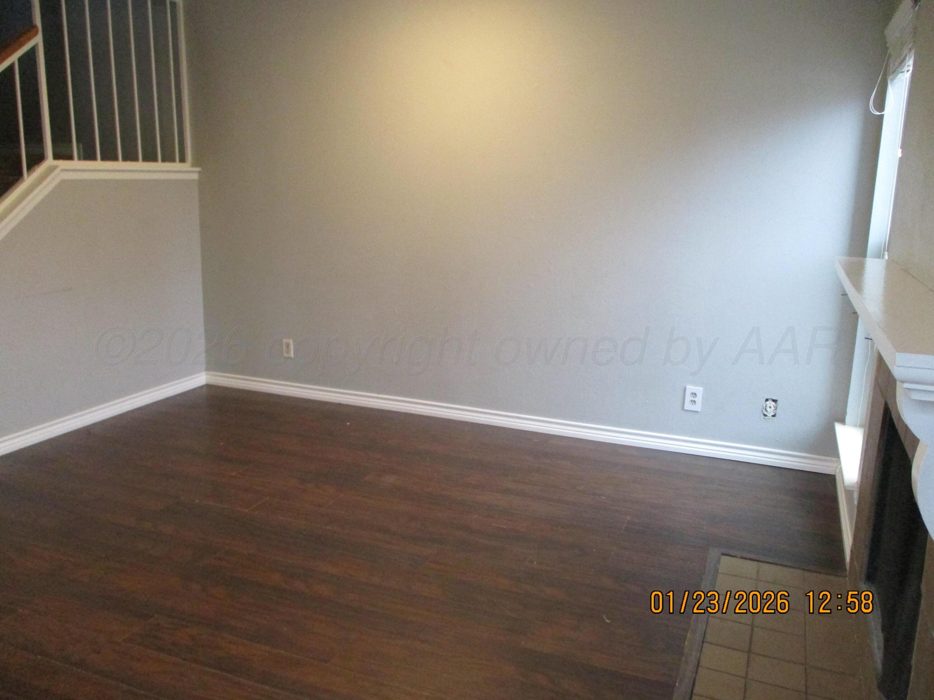 4500 South Virginia Street Amarillo, TX 79109 - Photo 3 of 8 a view of an empty room with wooden floor and a window