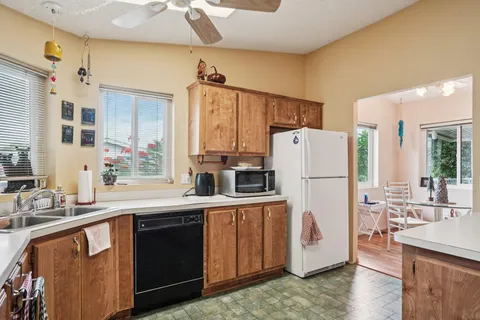 a kitchen with a sink a refrigerator and a stove